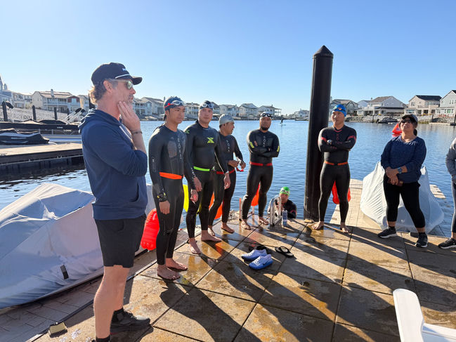 Coach Chris briefing open water swimmers