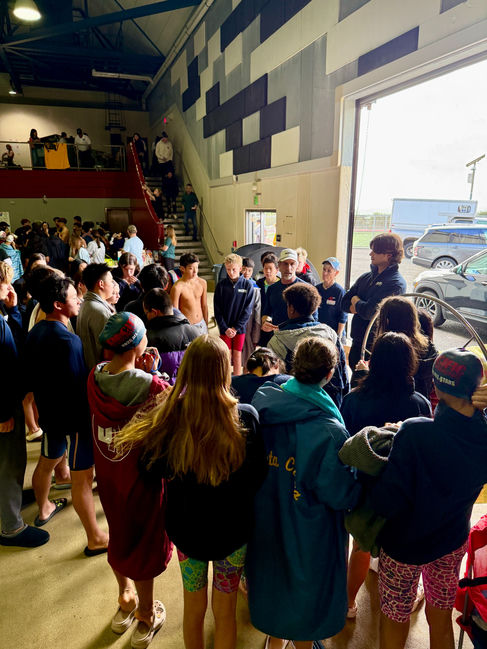Coach Chris addressing swimmers at a meet