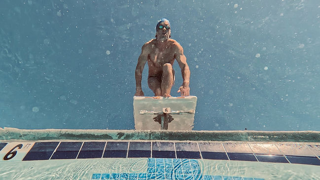 Swimmer off the starting block underwater
